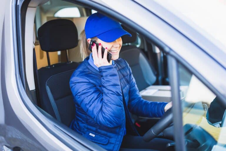 A woman working with the man and van driving the van in the concept of 'How to Get a Quote for a Man and Van Service in Slough'.